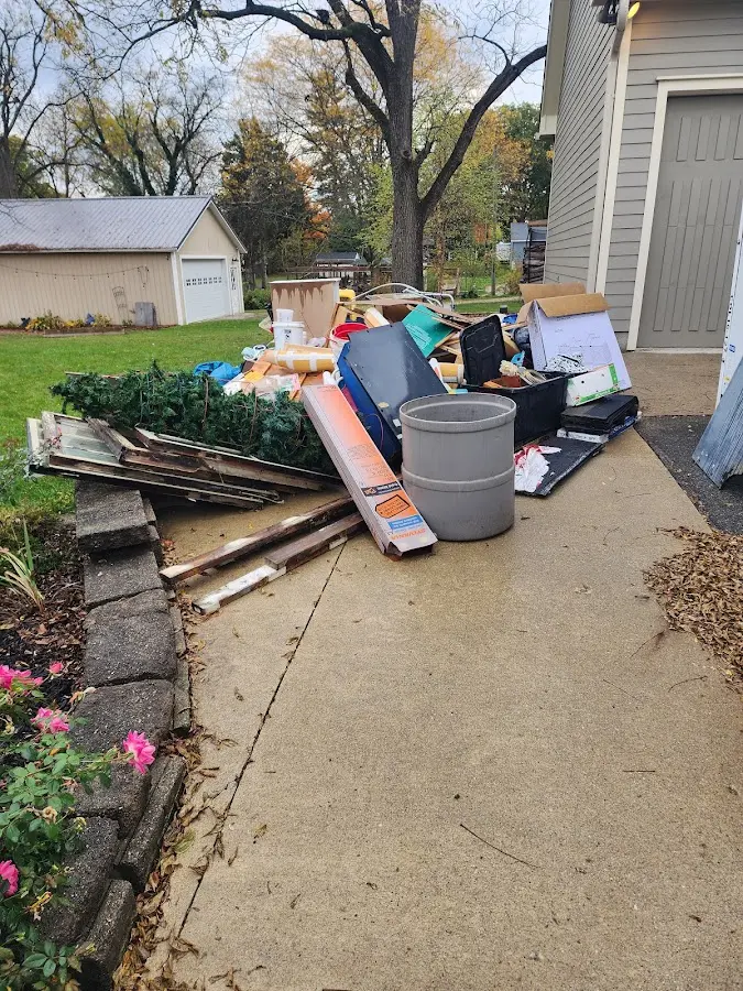 Dumpster being loaded with debris for 10 Yard Dumpster Rental in Eureka